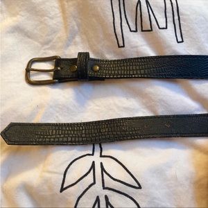 Black leather vintage belt patterned with tan suede underside and gold buckle